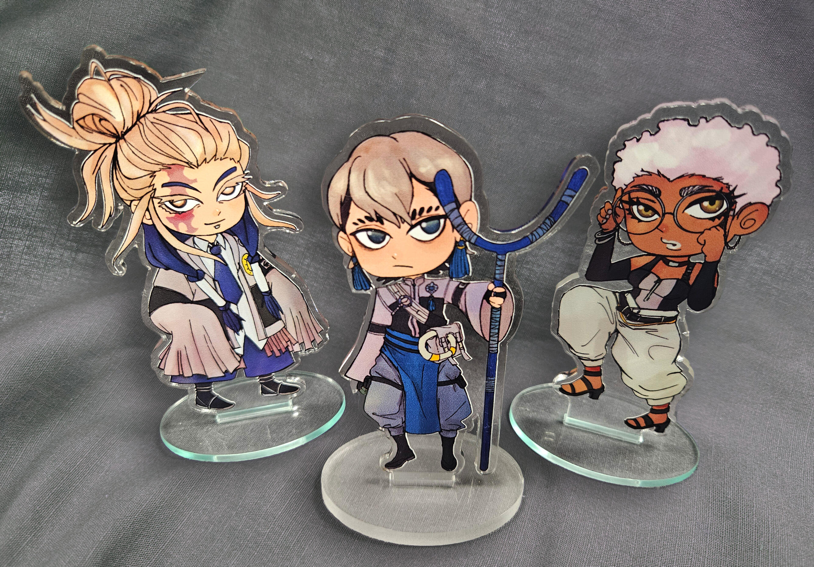Acrylic standees made of characters from the series Gachiakuta by Urana Kei.