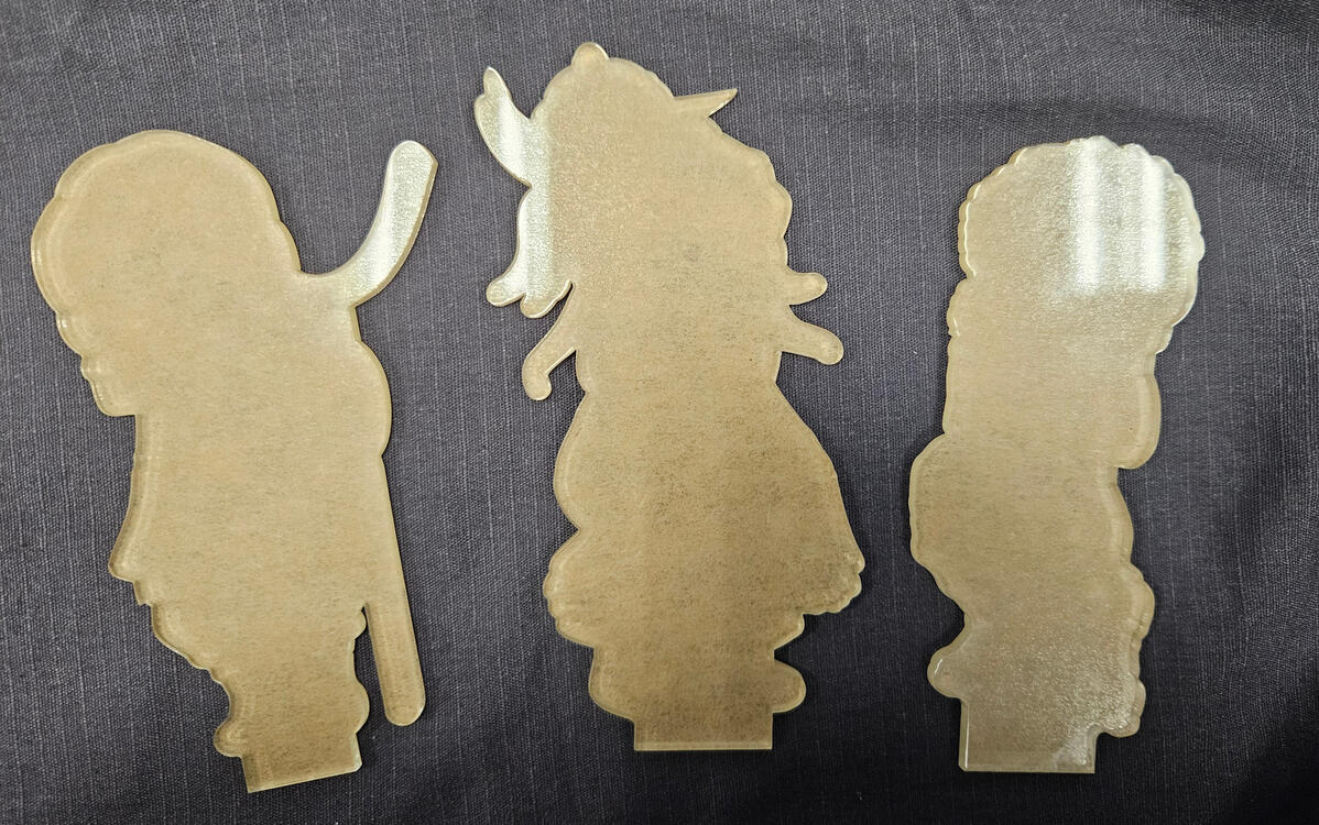 Laser-cut acrylic before flatbed printing.